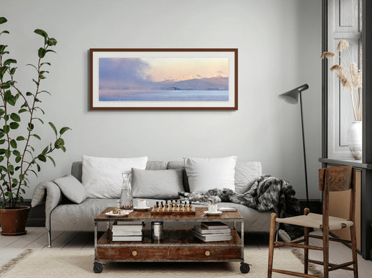 Living room with a sofa, coffee table, and framed picture on the wall.