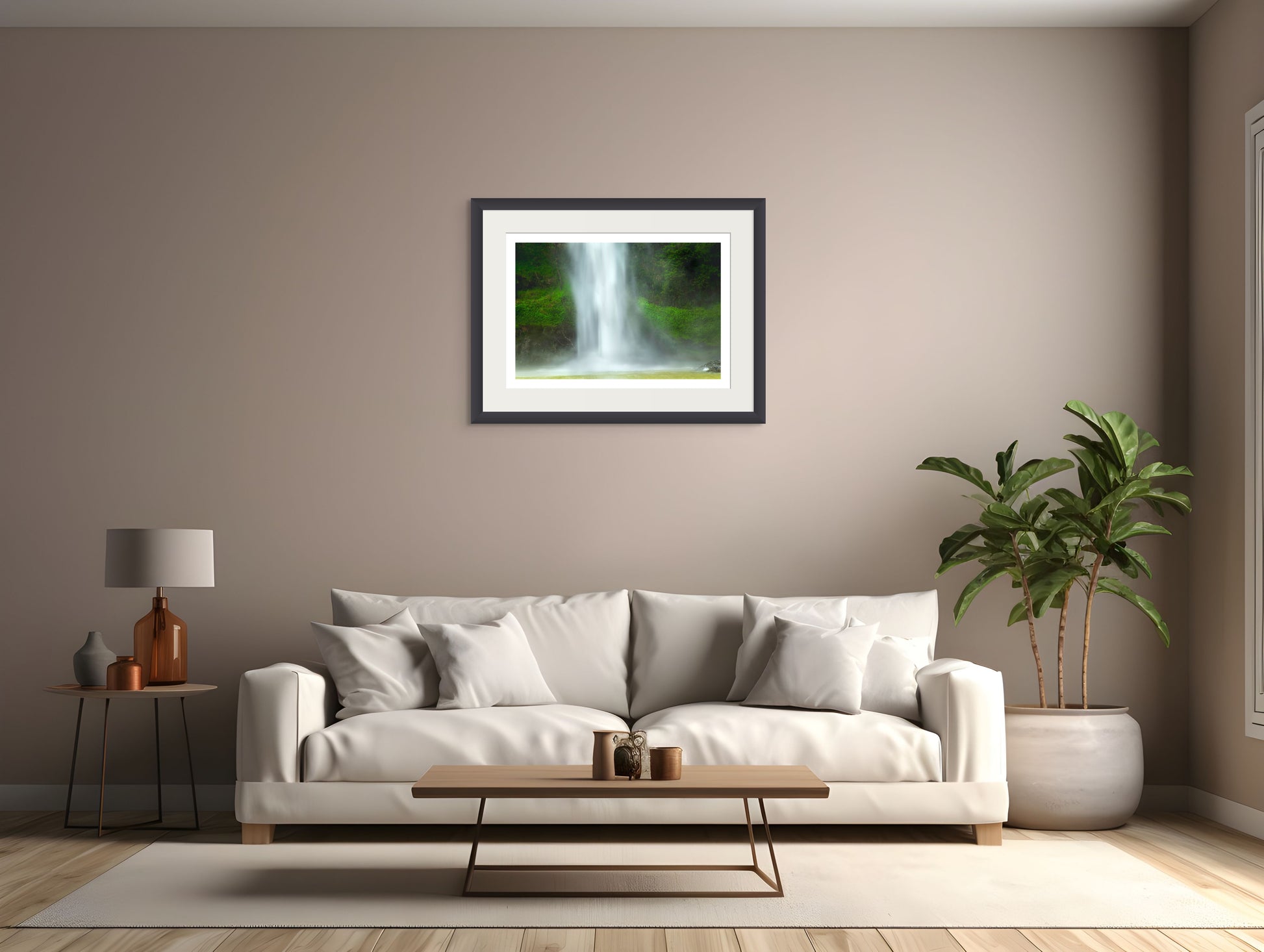 Modern living room with a white sofa, coffee table, and framed picture of a waterfall on the wall.