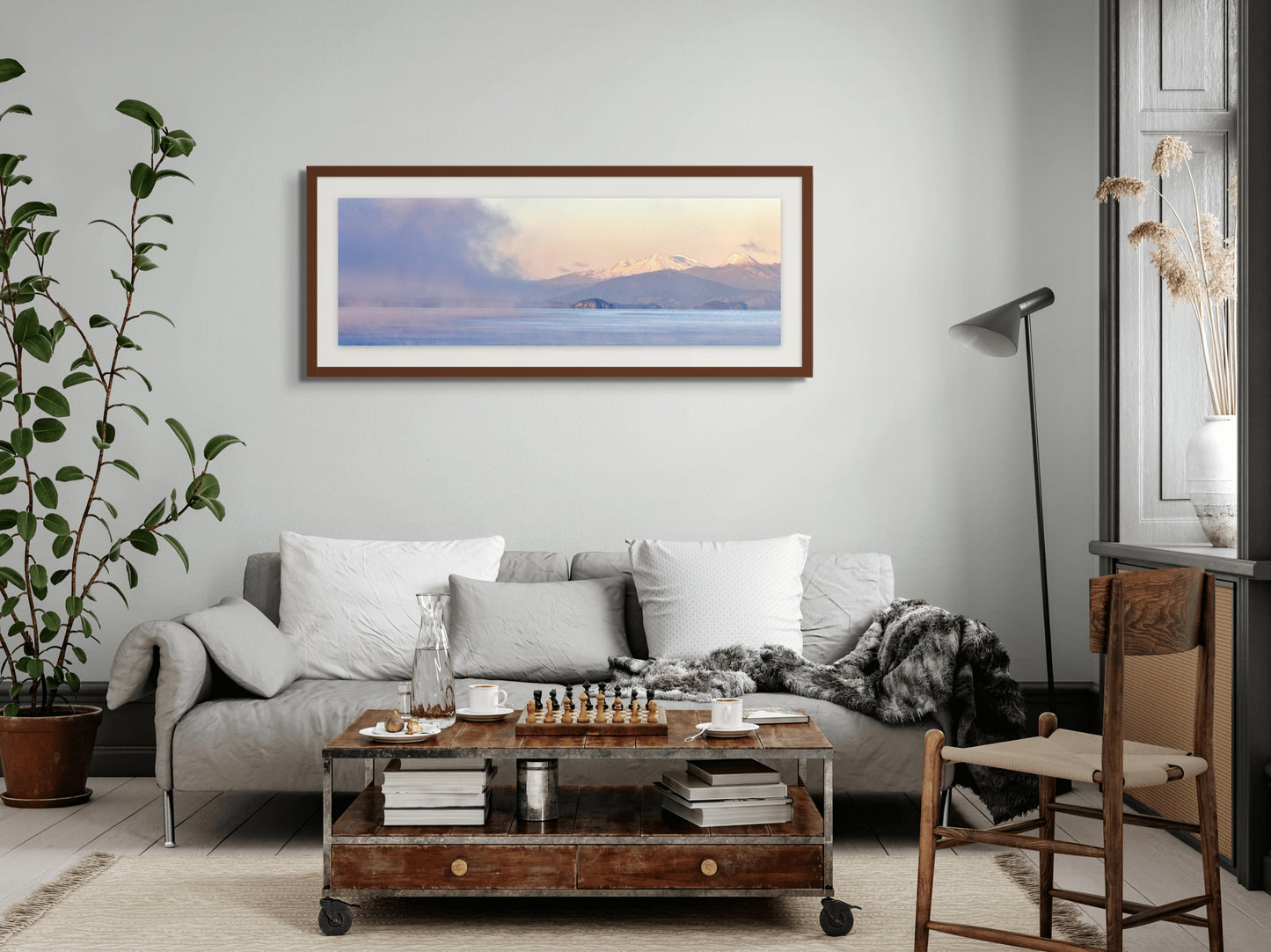 Living room with a sofa, coffee table, and framed picture on the wall.